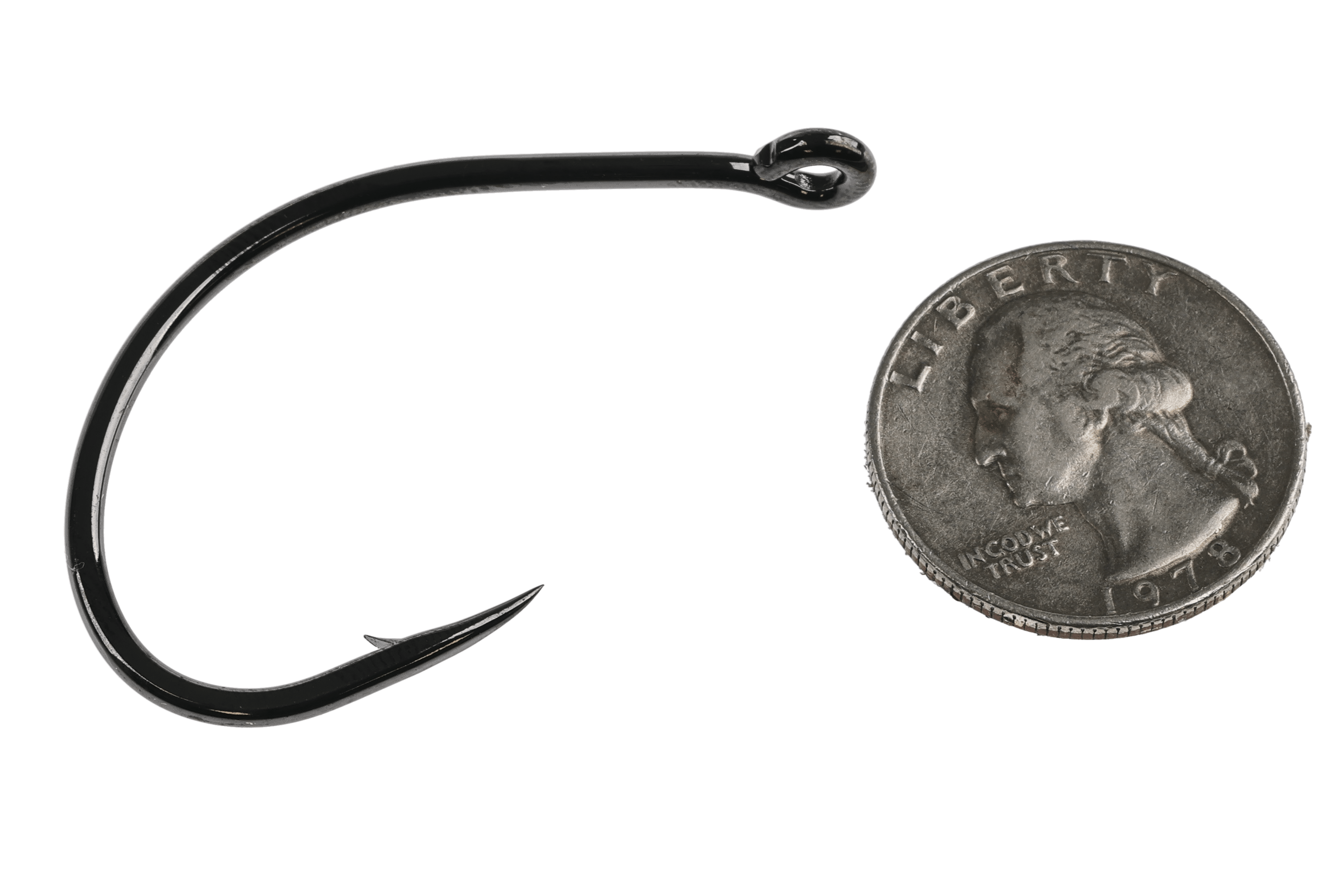 Black nickel short-keel streamer hook for fly tying with sharp needlepoint and small barb beside quarter for scale