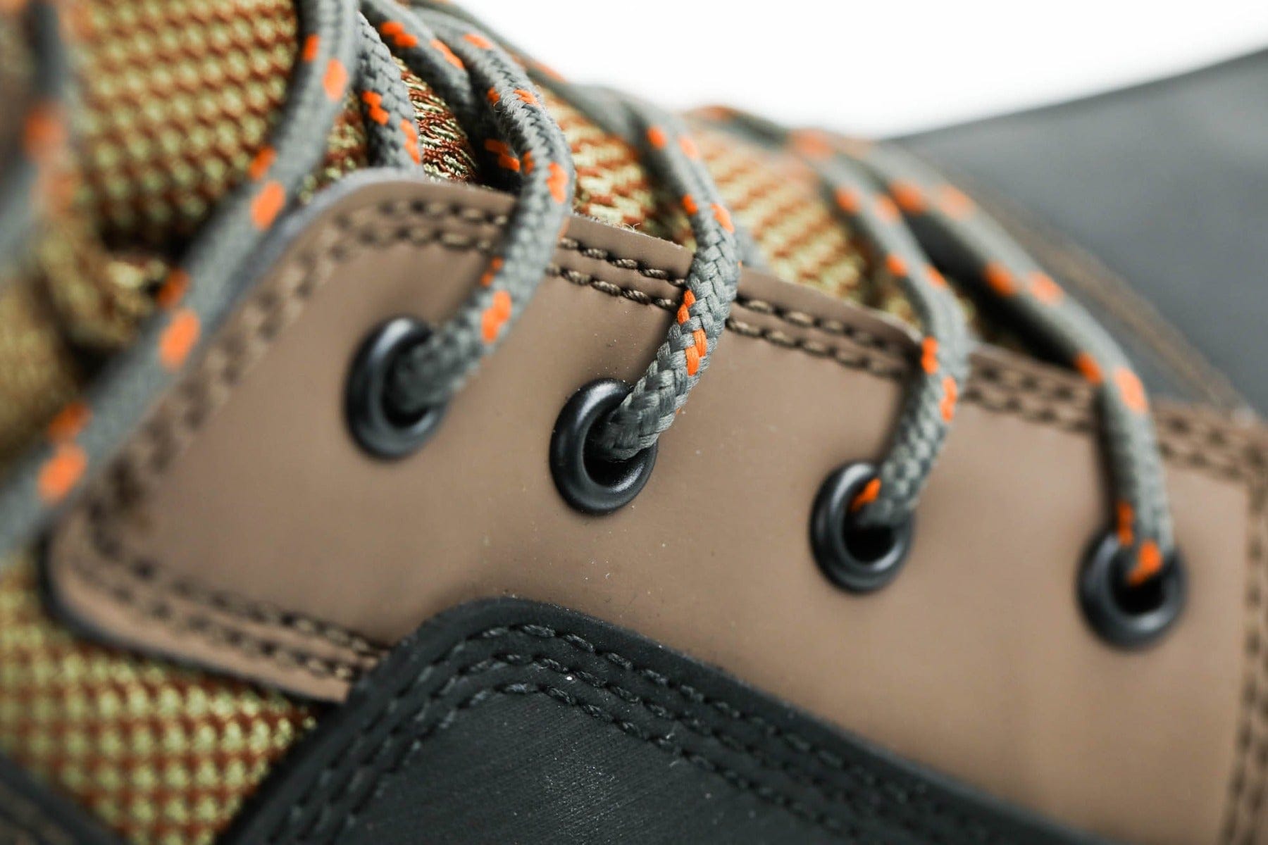 Korkers Buckskin wading boot close-up: brown leather upper, gray laces with orange flecks, black eyelets