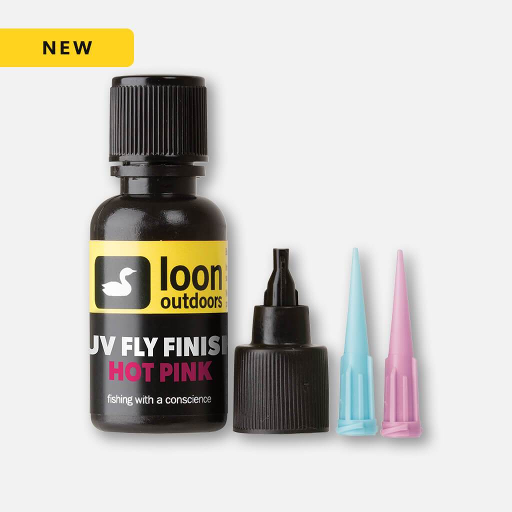 Loon UV fly finish (hot pink) in black bottle with yellow label, black cap, dispensing tip and blue and pink nozzles, fly