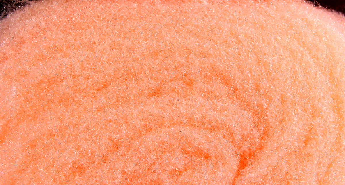 Peach-orange McFlyFoam fly tying yarn close-up showing soft, fuzzy foam fibers with subtle sparkle for tying flies