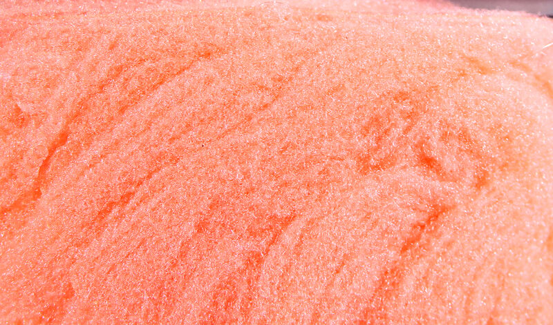 Peach-orange McFlyFoam fly tying yarn close-up showing shimmery synthetic foam fibers with textured, fluffy strands
