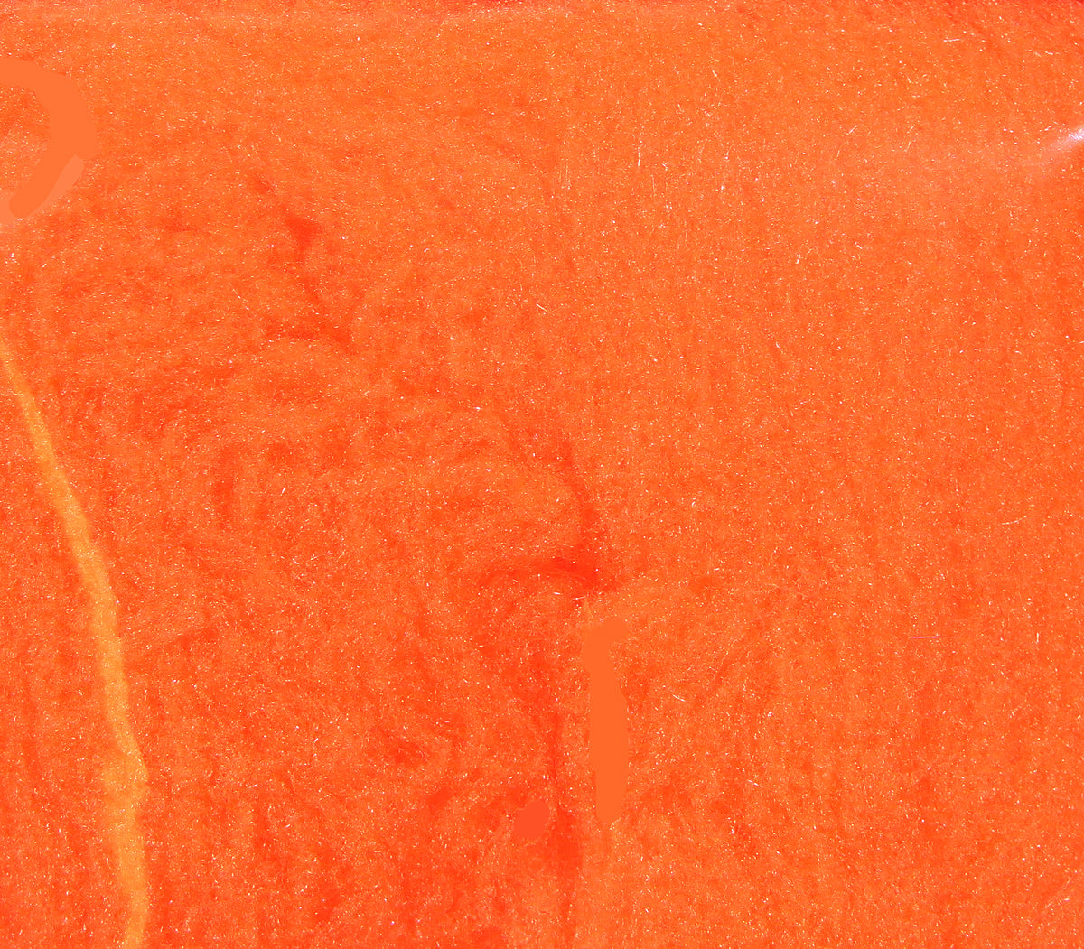 Bright fluorescent orange McFlyFoam fly tying yarn with soft foam texture and subtle glittery fibers