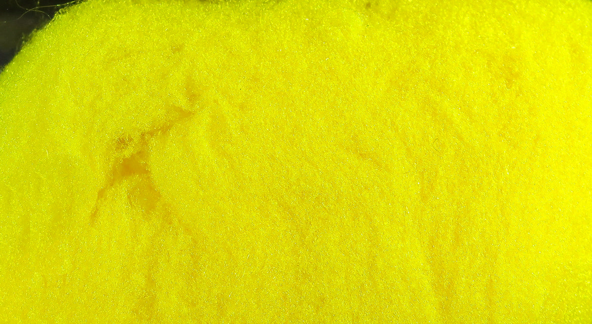 Bright chartreuse yellow McFlyFoam fly tying yarn close-up showing soft foam fiber texture for fly tying