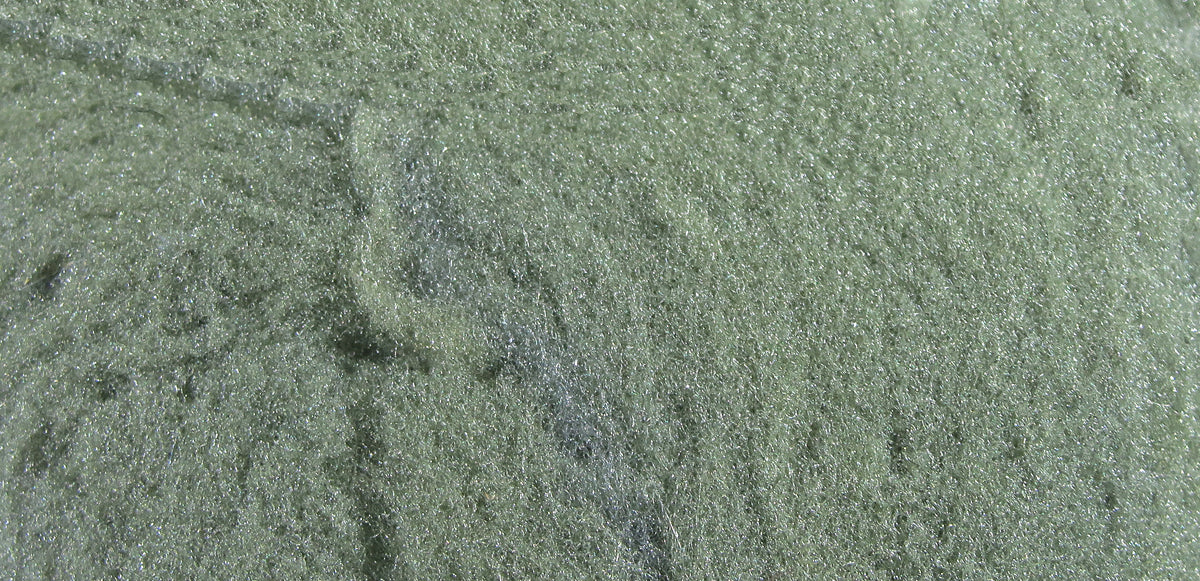 Olive green McFlyFoam fly tying yarn close-up showing sparkly fibrous foam texture