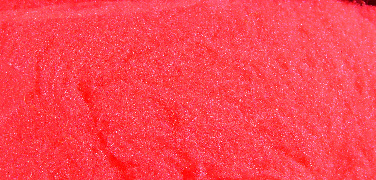 Bright neon red McFlyFoam fly tying yarn close-up showing dense spongy foam texture and fine shiny fibers