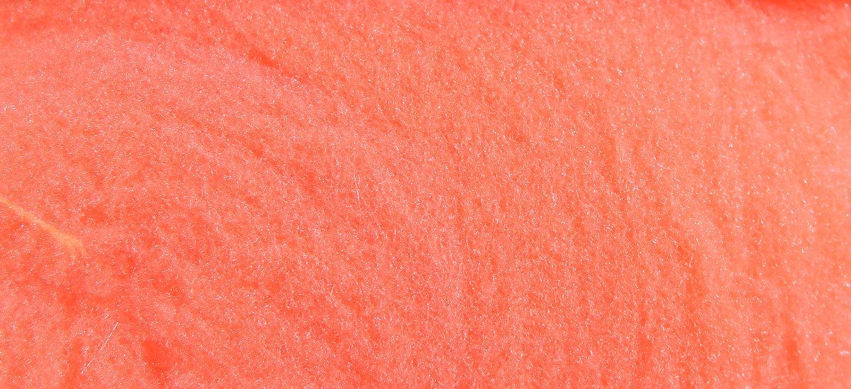 Coral orange McFlyFoam fly tying yarn close-up showing soft, sparkly synthetic foam fibers