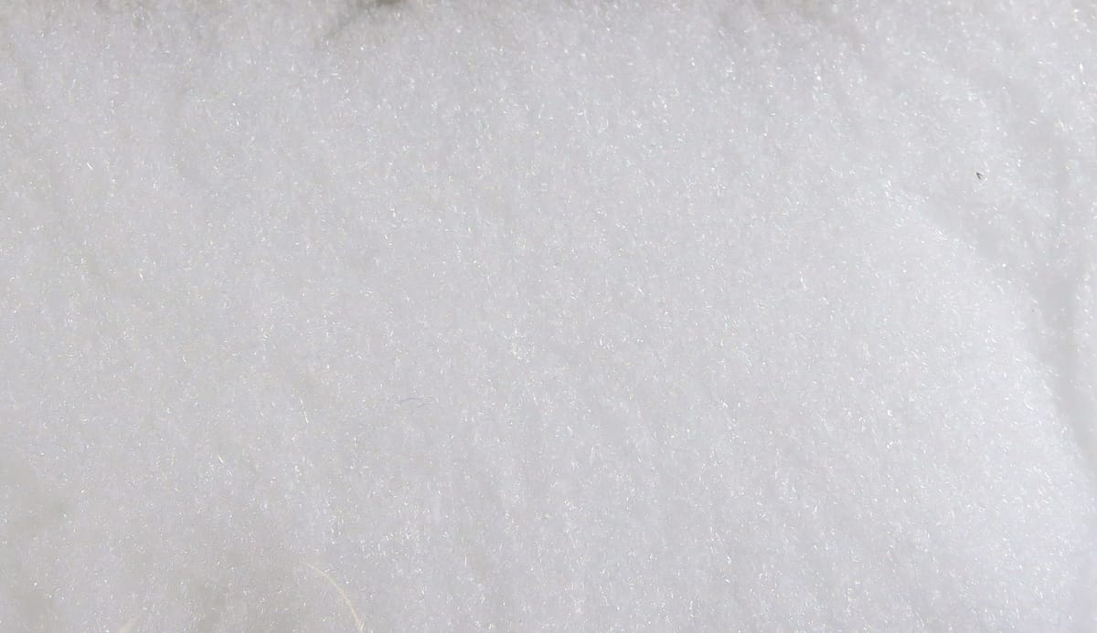 White McFlyFoam fly tying yarn sheet, soft fibrous foam texture with subtle iridescent sparkle