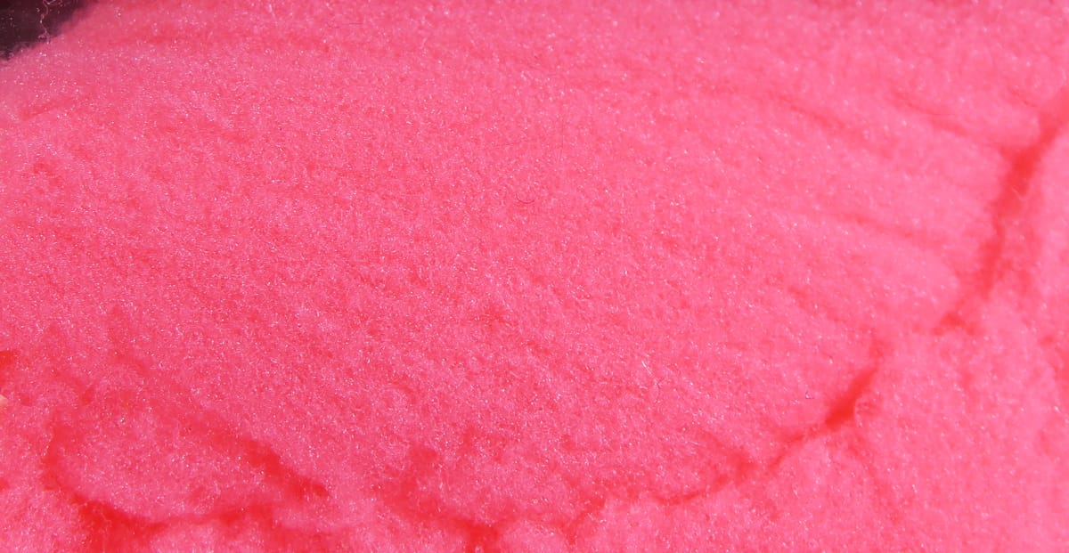 Bright neon pink McFlyFoam fly tying yarn close-up showing soft foam fiber texture