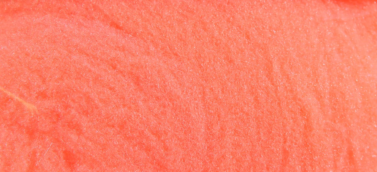 Coral orange McFlyFoam fly tying yarn close-up showing soft, sparkly synthetic foam fibers