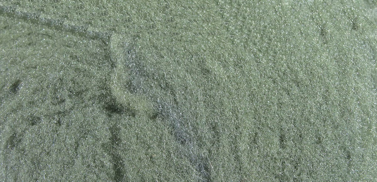 Olive green McFlyFoam fly tying yarn close-up showing sparkly fibrous foam texture