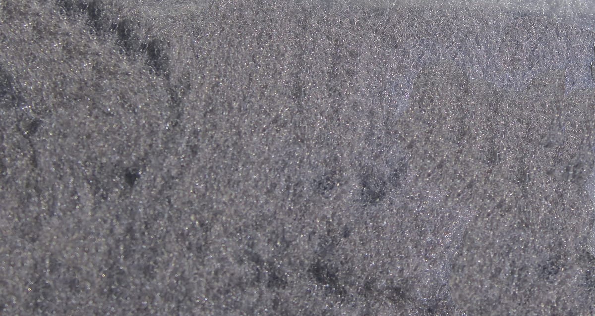 Gray McFlyFoam fly tying yarn close-up showing fine foam texture with subtle silver sparkle fibers