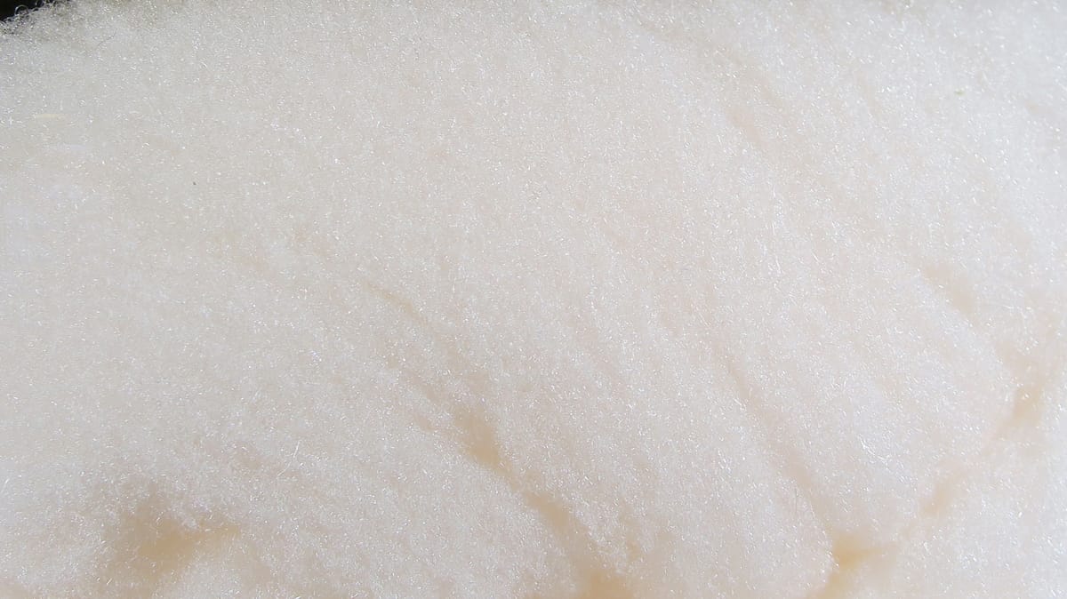 Cream McFlyFoam fly tying yarn showing fluffy synthetic foam fibers with subtle shimmer and fine texture