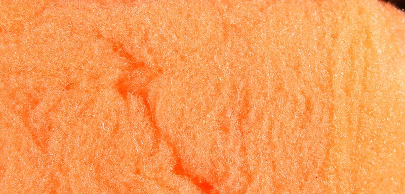Bright orange McFlyFoam fly tying yarn close-up showing soft foam fibers and textured surface