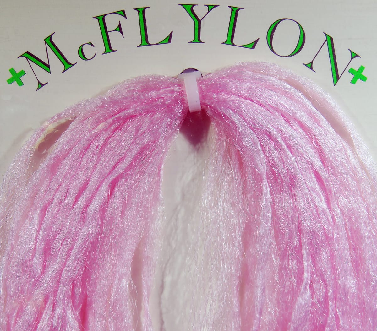 Pink shimmery PolyPro fly tying fibers, long glossy synthetic foam strands bundled with small plastic ring