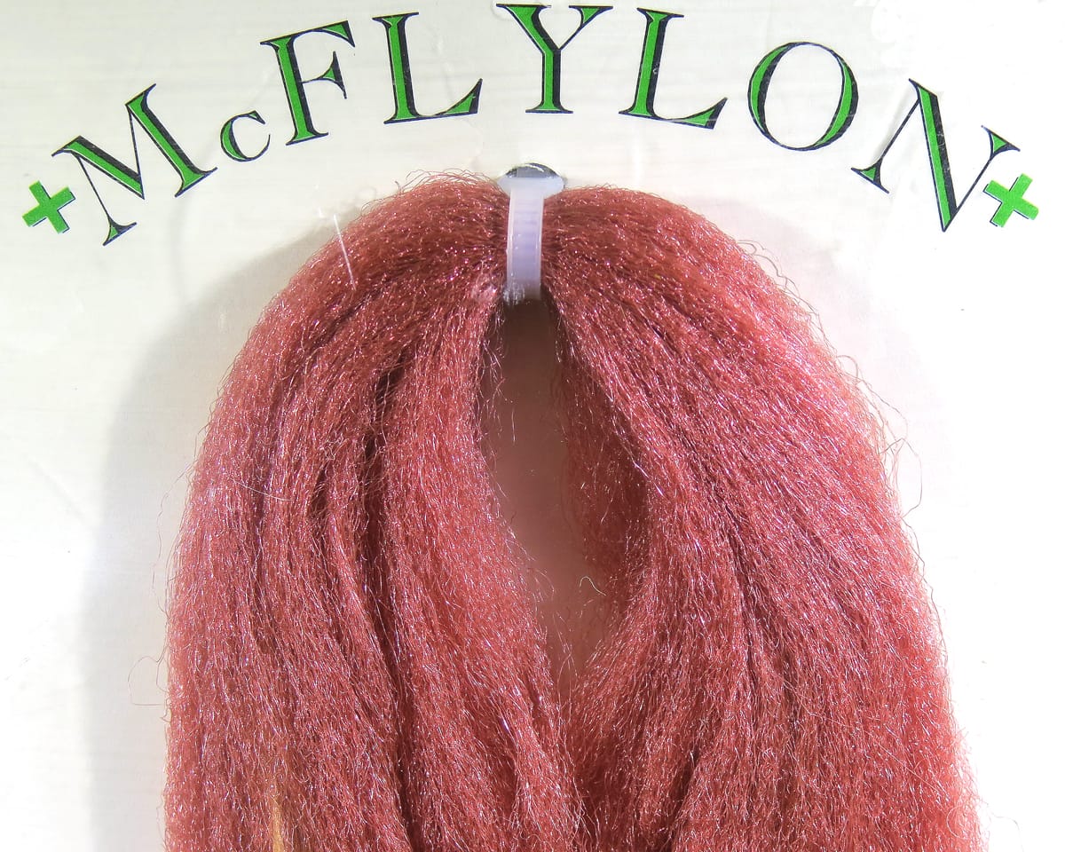 Copper-red shiny synthetic McFlylon fiber bundle for fly tying, looped PolyPro strands with glittery, hairlike texture