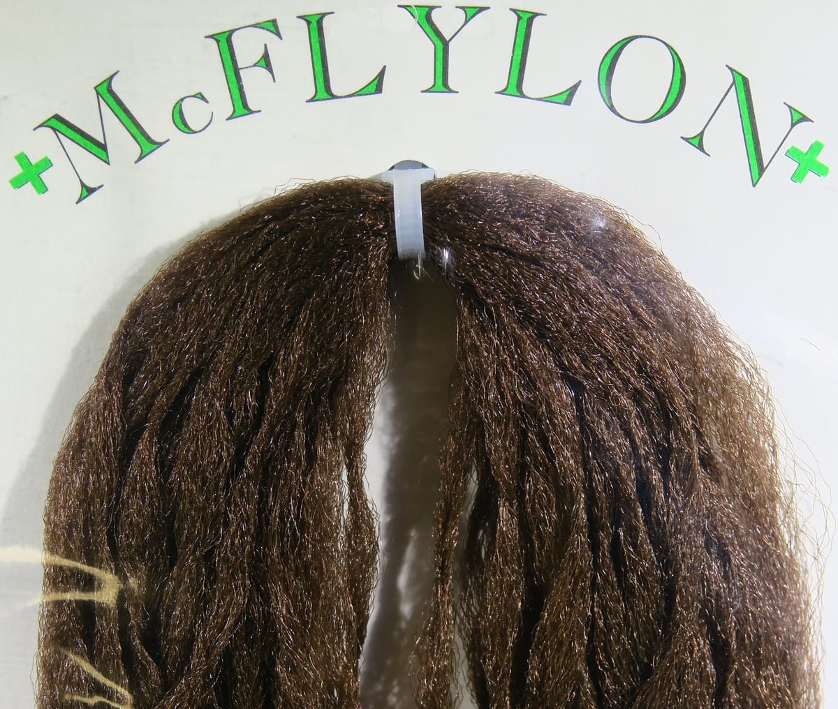 Brown McFlylon PolyPro synthetic fiber bundle for fly tying, glossy crimped nylon strands secured with a white plastic clip