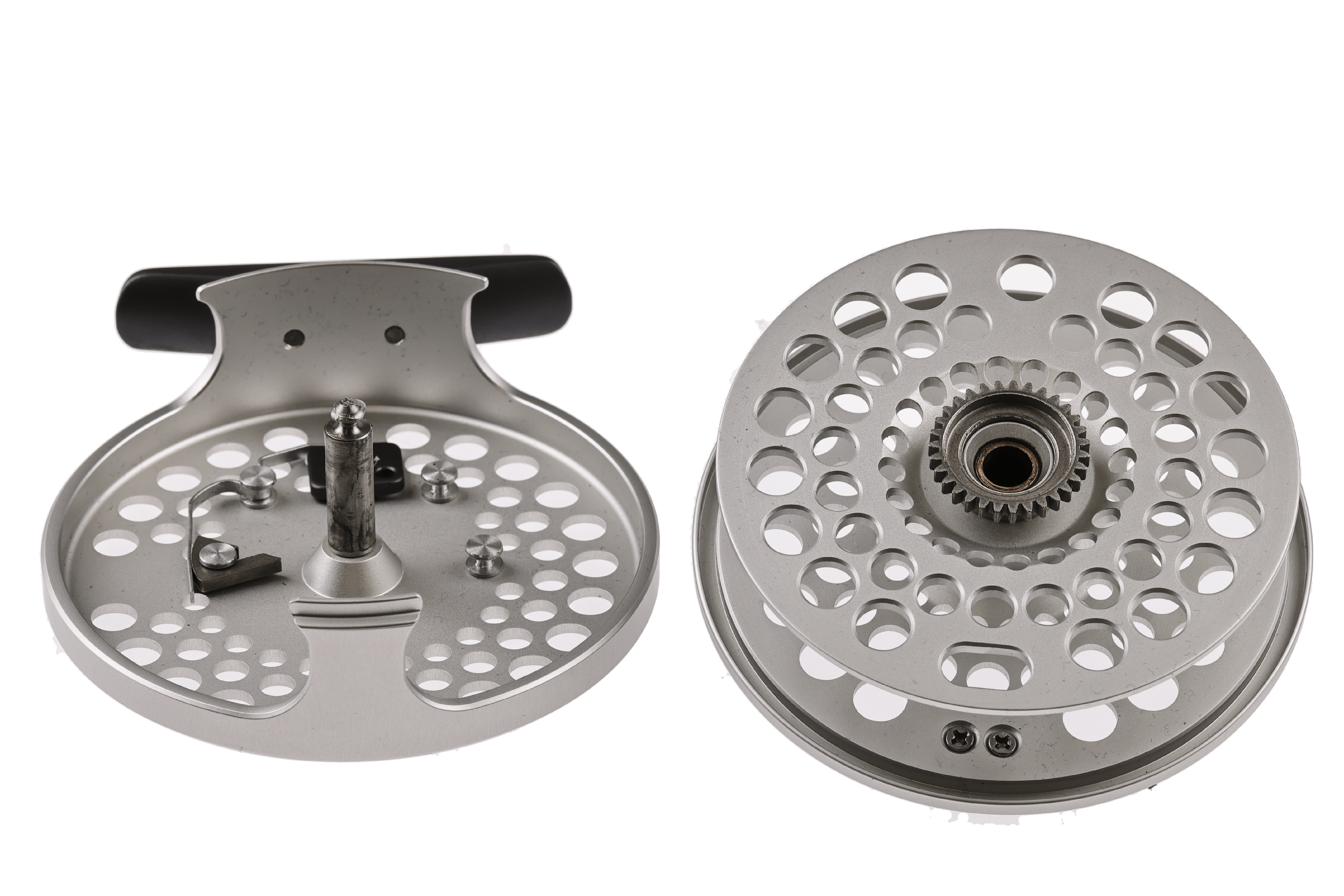 Silver Orvis Battenkill click fly reel halves showing perforated aluminum spool, gear hub and black handle knob