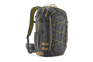 Charcoal gray Patagonia 25L nylon stealth backpack with olive bungee front, tan accents, padded straps and side water pocket