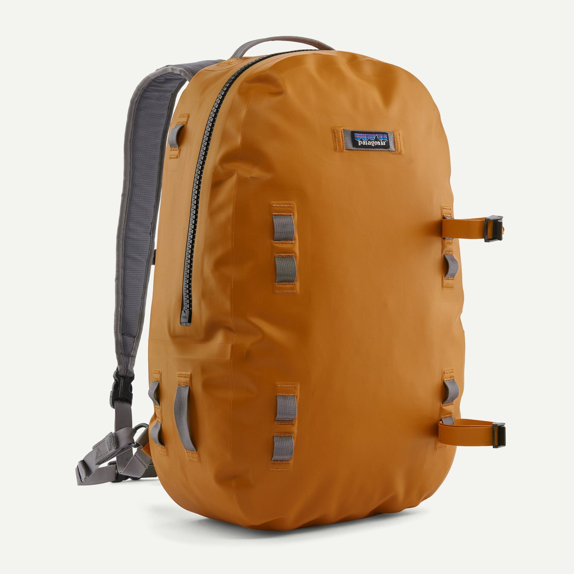 Burnt-orange Patagonia backpack with coated waterproof fabric, gray padded straps, YKK front zipper and daisy-chain gear