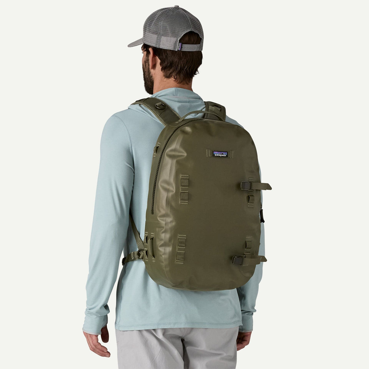 Olive green Patagonia Guidewater backpack with matte waterproof shell, padded shoulder straps and daisy-chain lash points