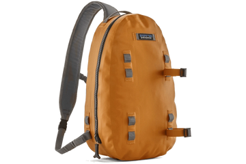 Patagonia Guidewater sling pack amber orange coated fabric, gray padded strap, vertical zipper and webbing attachment loops