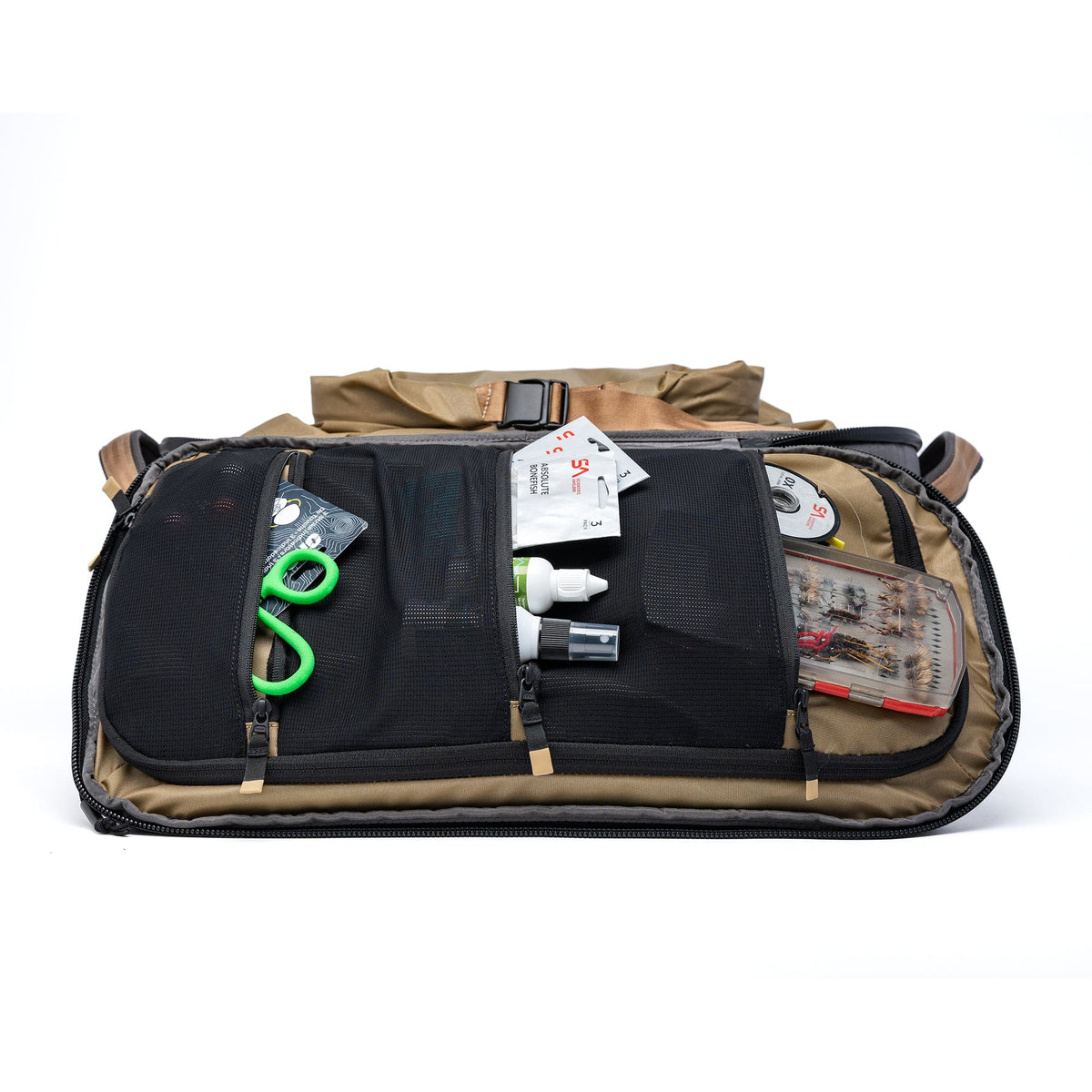 Tan and black waterproof duffel bag open with organized compartments displaying fishing gear, carabiners, and accessories