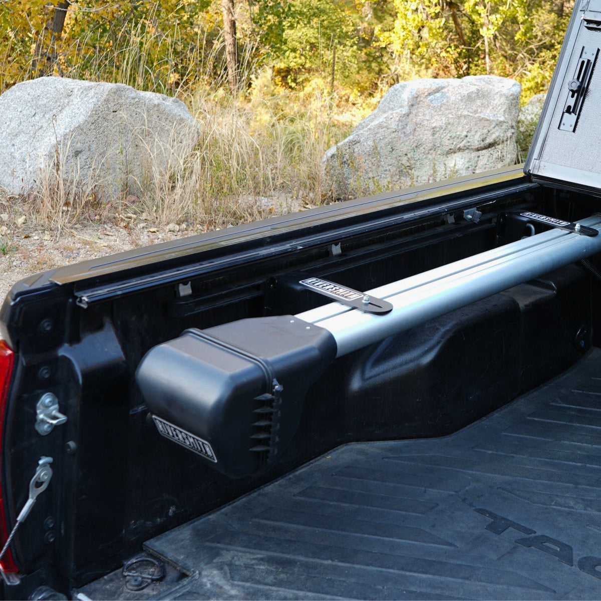 Riversmith Truck Bed River Quiver fishing rod rack mounted on black pickup truck bed with aluminum bars