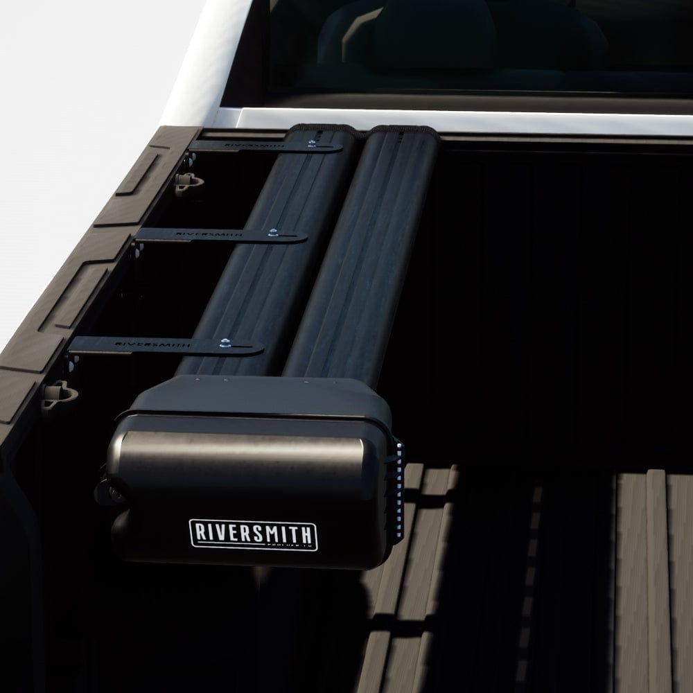 Riversmith black truck bed fishing rod rack mounted on white pickup truck bed rails