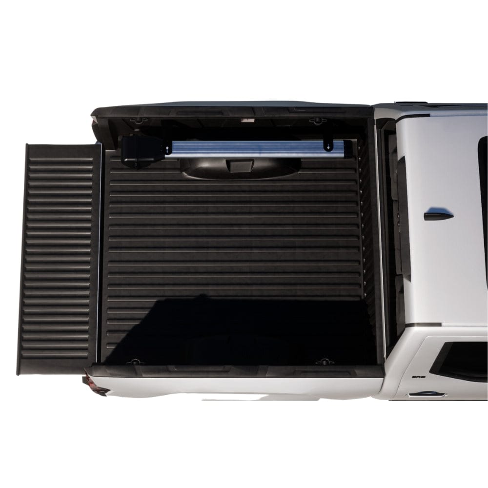 Riversmith Truck Bed River Quiver black aluminum fishing rod holder mounted on white pickup truck bed