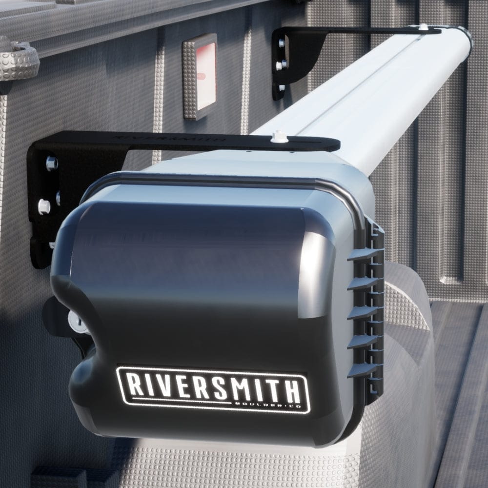 Riversmith black truck bed rod holder mounted on white aluminum rail with vertical storage slots for fishing rods