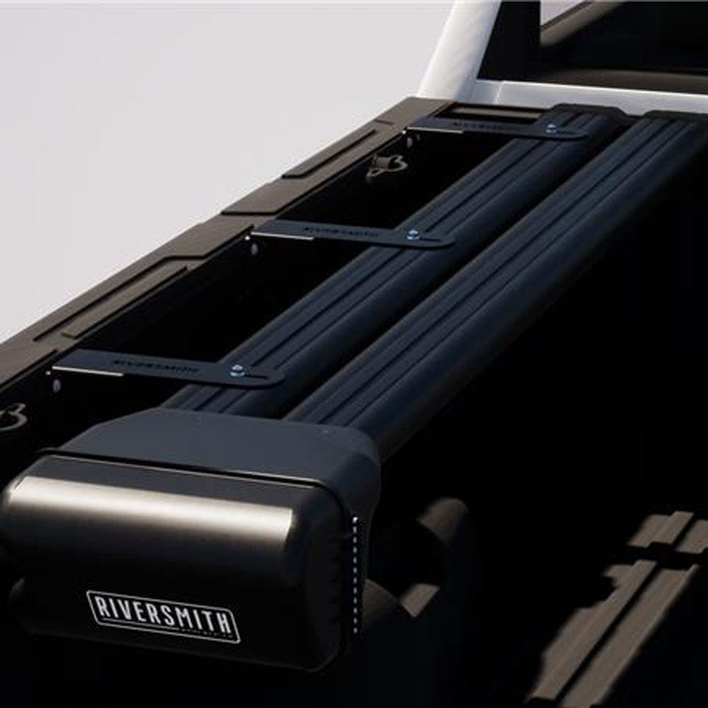 Riversmith black aluminum truck bed rod rack mounted on pickup with multiple fishing rod holders and secure storage