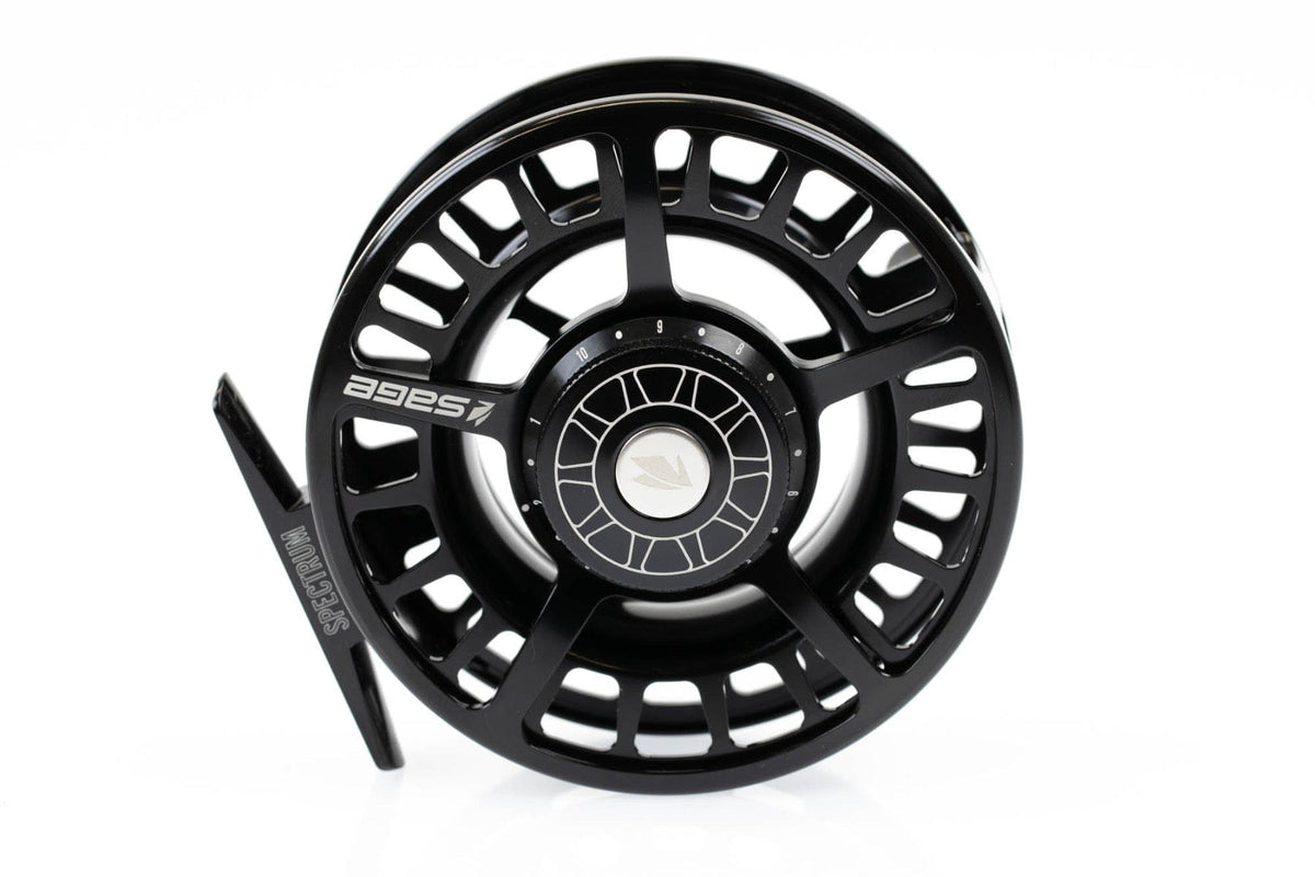 Black machined-aluminum Sage Spectrum large-arbor fly reel with ventilated spool, engraved logo and adjustable drag knob