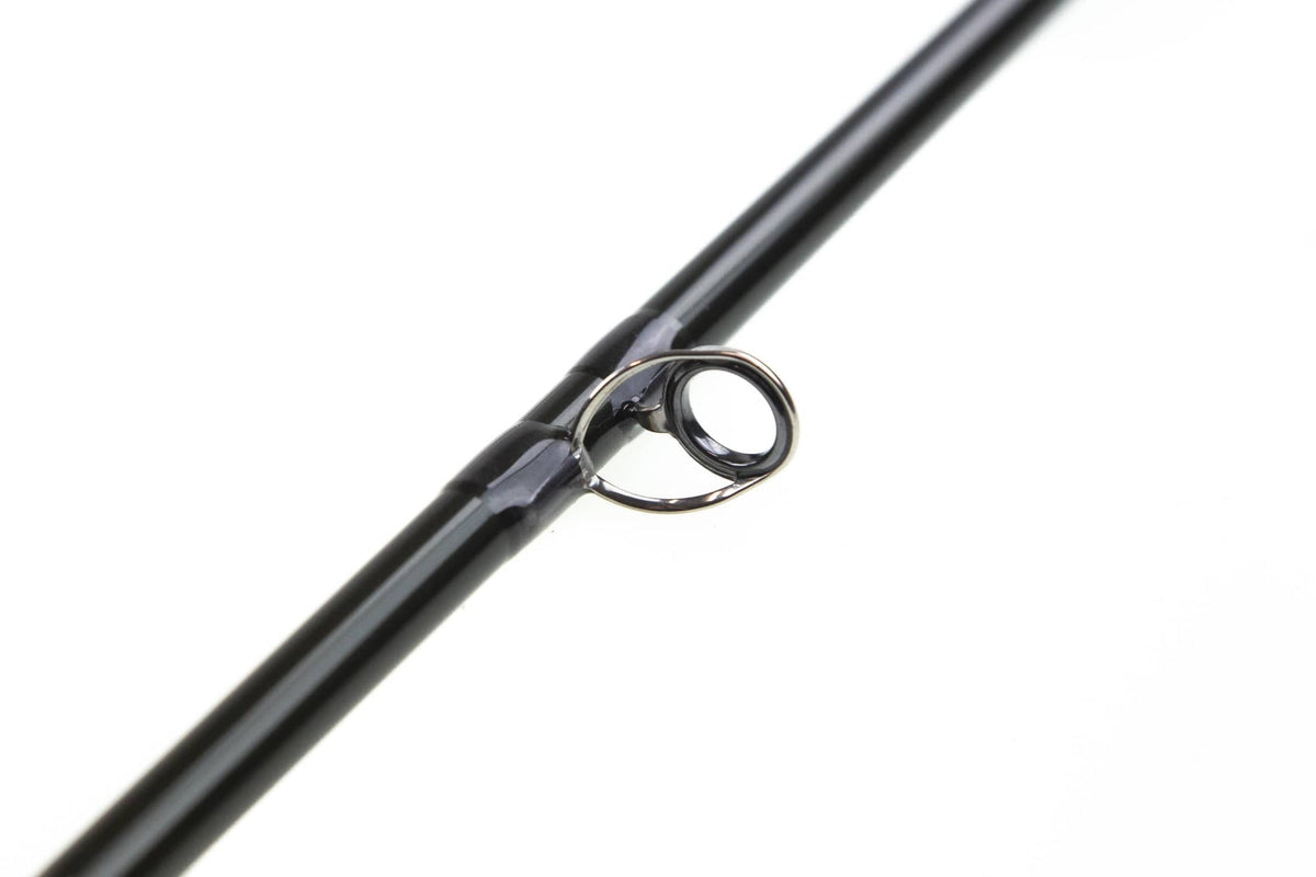 Sage R8 Core glossy black carbon fly rod close-up of metal guide on smooth graphite blank