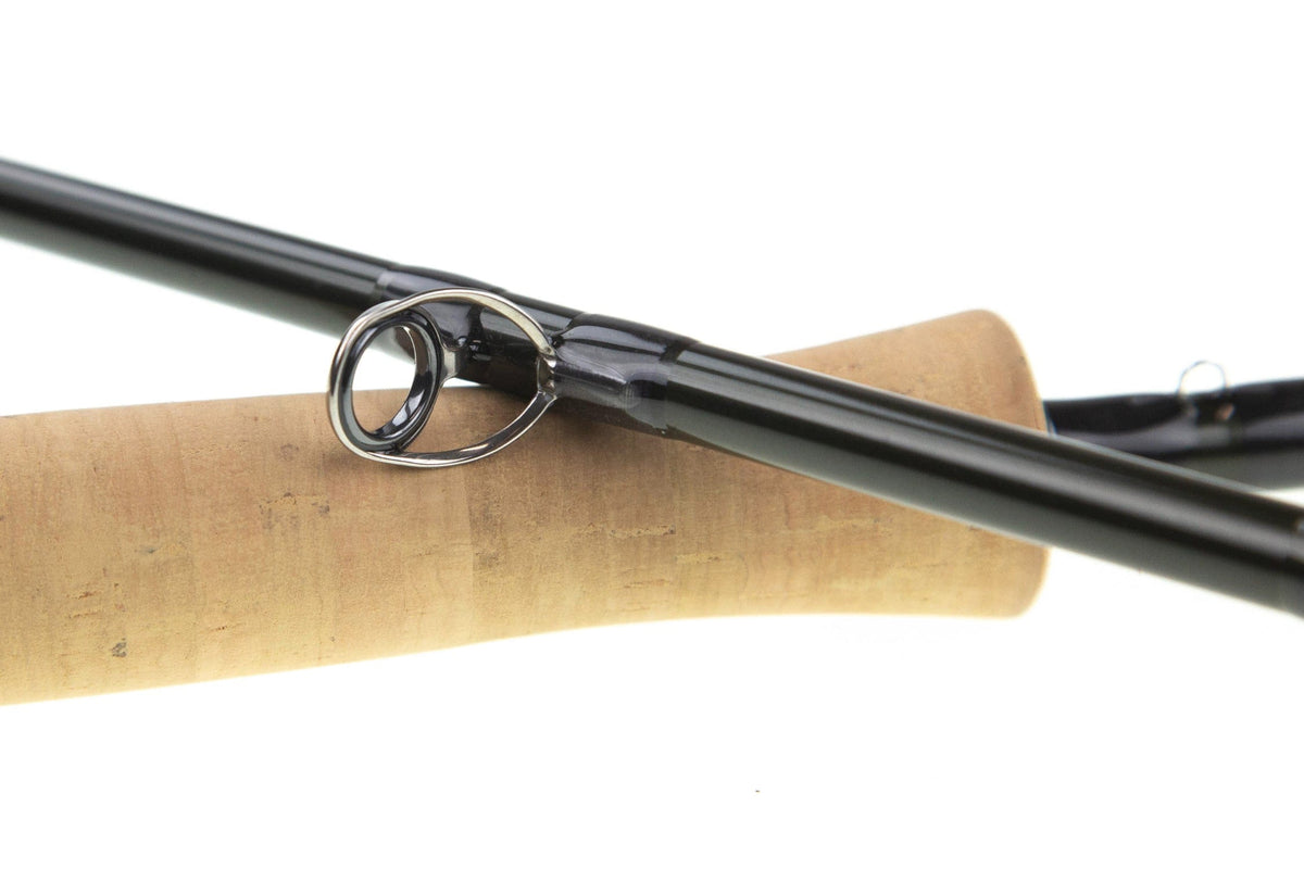 Sage R8 Core fly rod black carbon blank with stainless steel guide and cork handle close-up