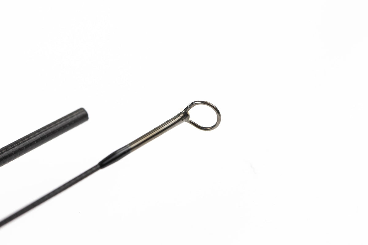 Scott Centric fly rod tip with black carbon blank and polished metal guide ring, slim graphite construction