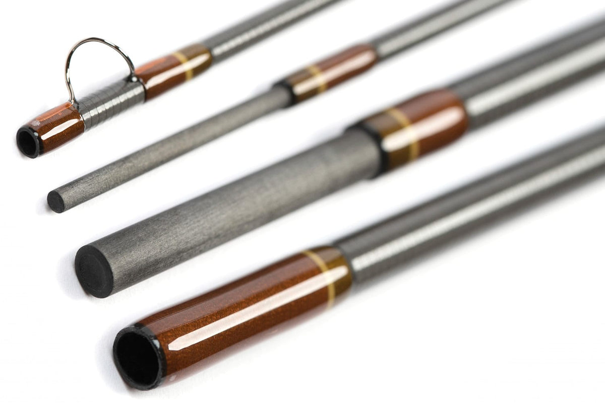 Scott G Series fly rod close-up showing gray carbon fiber blank, brown gloss ferrules, gold trim and guide ring