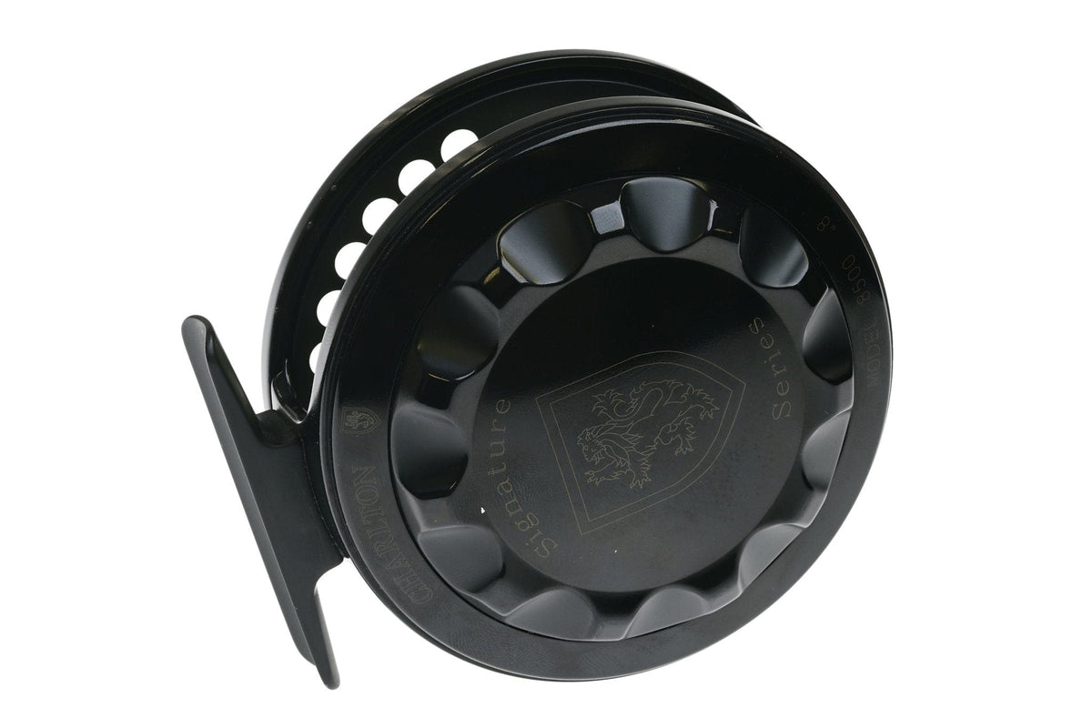 Black anodized Charlton 8500 Signature Series fly reel with scalloped spool, vented holes and engraved crest