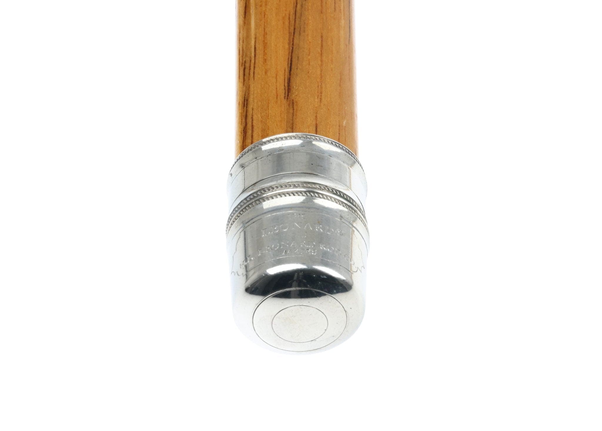 Honey wood fly rod blank with polished silver reel seat showing engraved rings and metal butt cap