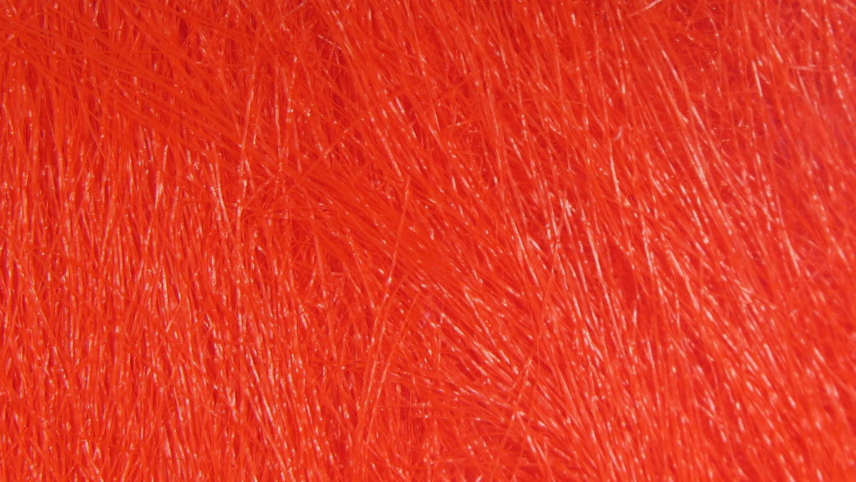 Bright fluorescent orange-red synthetic craft fur with dense, fine glossy fibers for fly tying