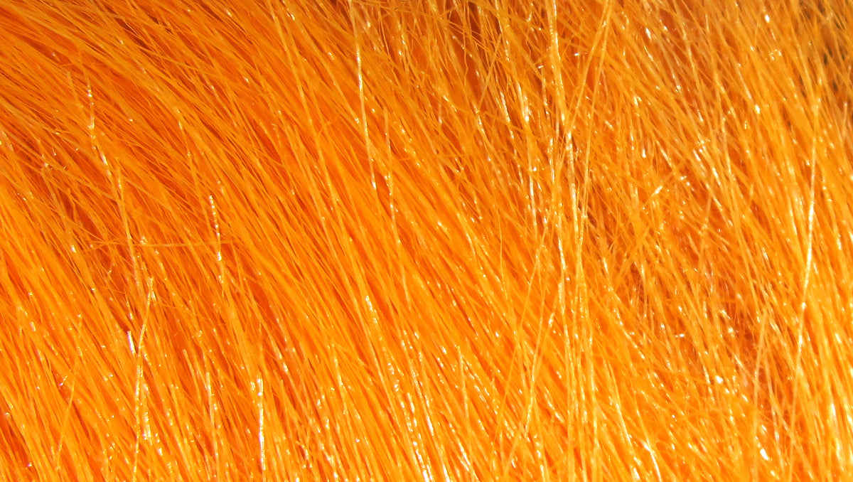 Bright orange Hareline craft fur fibers with glossy synthetic strands for fly tying
